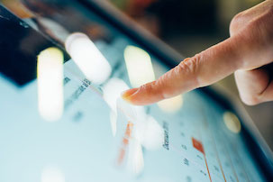 Close up on a finger touching the screen of a tablet - technology